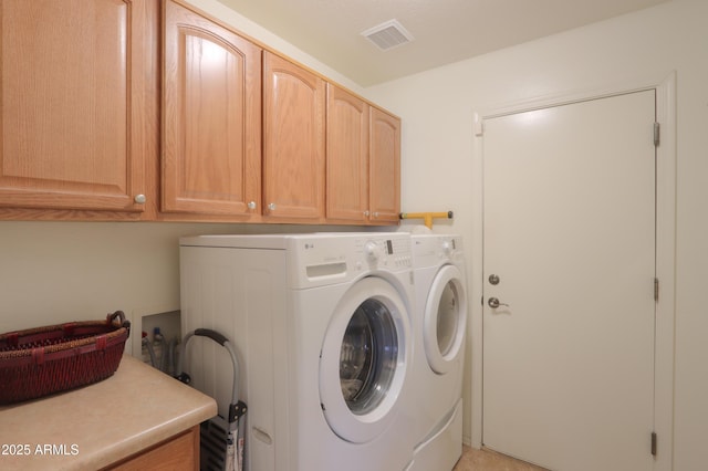 laundry area featuring cabinet space, visible vents, and washer and clothes dryer