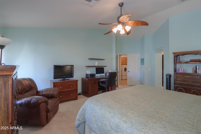 bedroom featuring washer / clothes dryer, light colored carpet, visible vents, a ceiling fan, and high vaulted ceiling