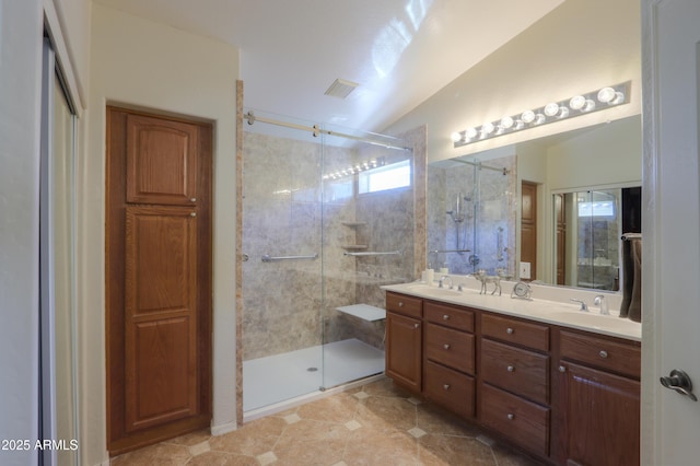 full bathroom with lofted ceiling, a sink, visible vents, a shower stall, and double vanity