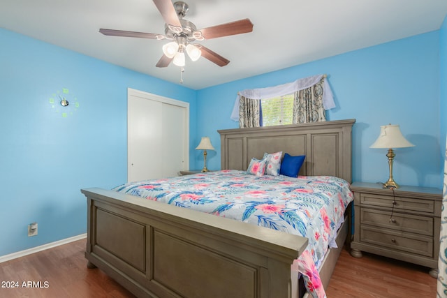 bedroom featuring dark hardwood / wood-style floors, ceiling fan, and a closet