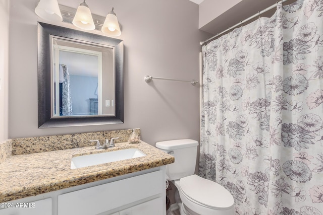 bathroom featuring toilet and vanity