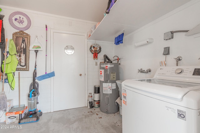 laundry room featuring electric water heater and washer / dryer