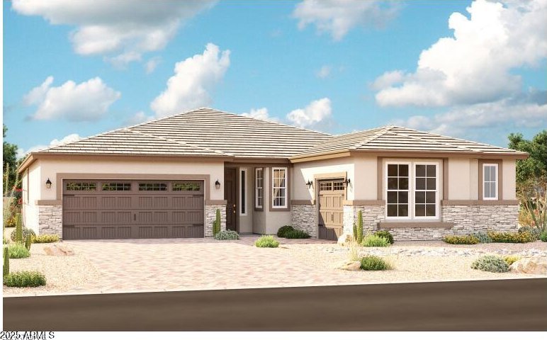 20179 W Monterey Way, Buckeye, AZ 85396 - prairie-style home featuring stone siding, a garage, stucco siding, and decorative driveway