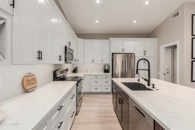6357 W Potter Dr, Glendale, AZ 85308 - kitchen with appliances with stainless steel finishes, a sink, white cabinetry, recessed lighting, and light wood finished floors
