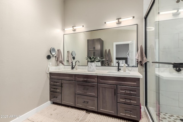 6357 W Potter Dr, Glendale, AZ 85308 - bathroom featuring a shower stall, double vanity, and baseboards