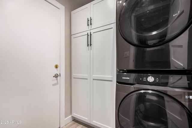 6357 W Potter Dr, Glendale, AZ 85308 - laundry area featuring cabinet space, stacked washing machine and dryer, baseboards, and light wood-style flooring