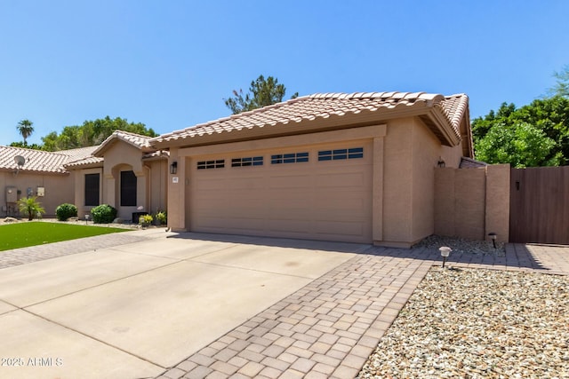 6357 W Potter Dr, Glendale, AZ 85308 - mediterranean / spanish house with stucco siding, concrete driveway, a garage, and a tile roof