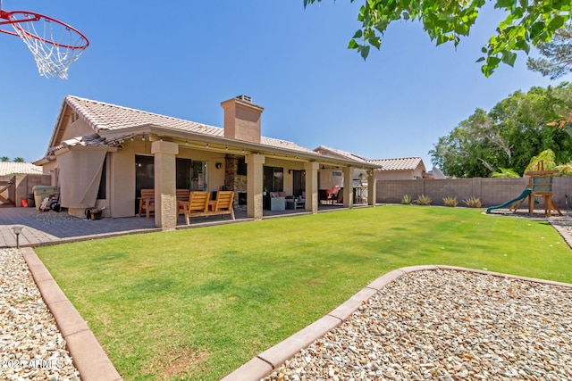 6357 W Potter Dr, Glendale, AZ 85308 - rear view of property featuring outdoor lounge area, a patio, a playground, a chimney, and stucco siding