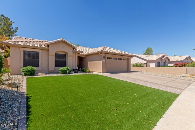 6357 W Potter Dr, Glendale, AZ 85308 - mediterranean / spanish-style home featuring a tile roof, stucco siding, a garage, and driveway