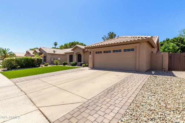 6357 W Potter Dr, Glendale, AZ 85308 - mediterranean / spanish-style house with an attached garage, stucco siding, concrete driveway, and a tiled roof