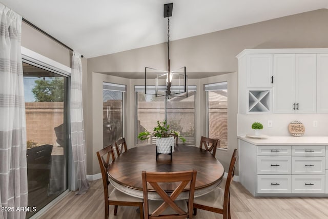 6357 W Potter Dr, Glendale, AZ 85308 - dining room featuring lofted ceiling, a chandelier, light wood-type flooring, and baseboards