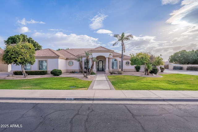 mediterranean / spanish-style house with a front lawn