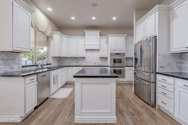 kitchen with sink, white cabinets, and stainless steel appliances