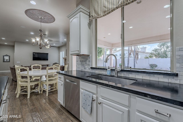 kitchen with backsplash, sink, stainless steel dishwasher, ceiling fan, and white cabinetry