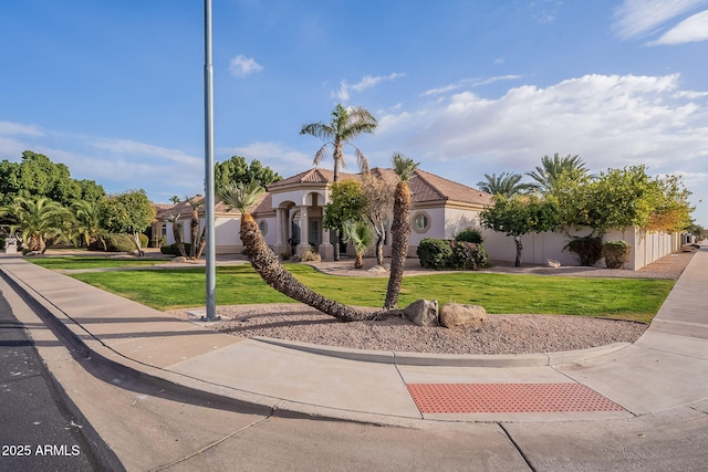 mediterranean / spanish-style home featuring a front lawn