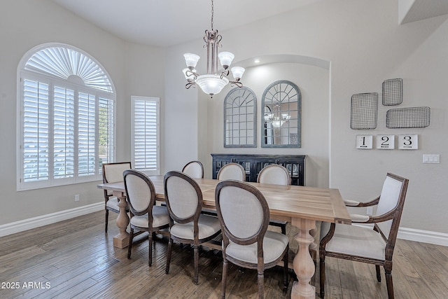 dining room featuring hardwood / wood-style floors and an inviting chandelier