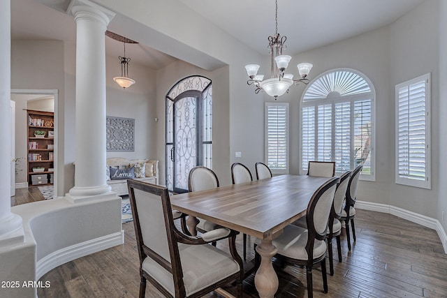 dining room with decorative columns, an inviting chandelier, and dark wood-type flooring