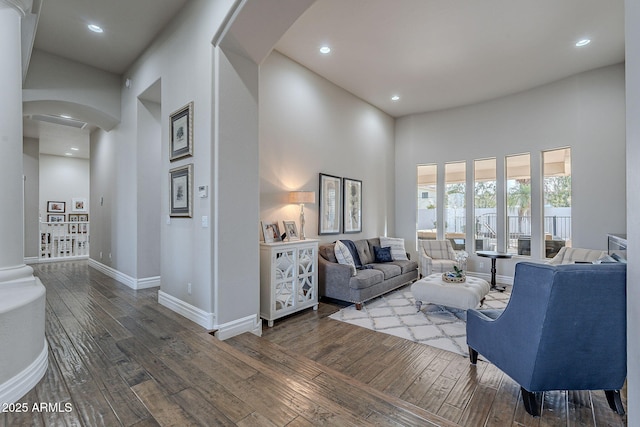 living room featuring dark hardwood / wood-style flooring and a high ceiling