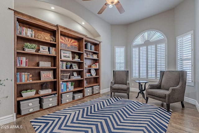 living area with hardwood / wood-style flooring and ceiling fan