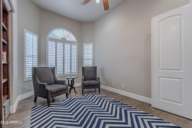 sitting room with light wood-type flooring and ceiling fan