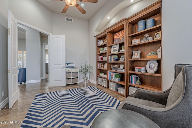 sitting room featuring wood-type flooring and ceiling fan