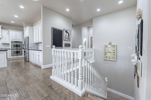 stairs featuring hardwood / wood-style floors