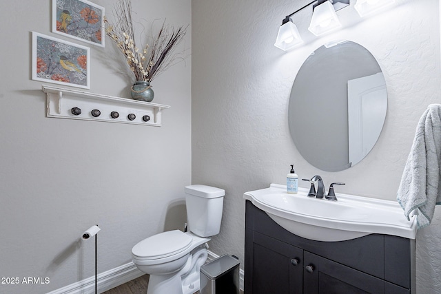 bathroom featuring hardwood / wood-style flooring, vanity, and toilet