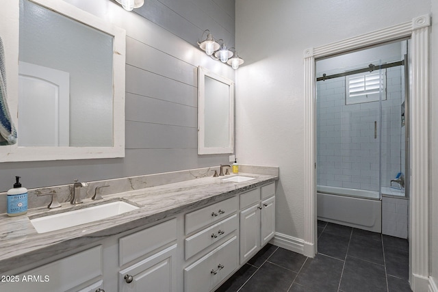 bathroom featuring tile patterned floors, vanity, and enclosed tub / shower combo