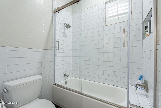 bathroom featuring toilet, tile walls, and enclosed tub / shower combo