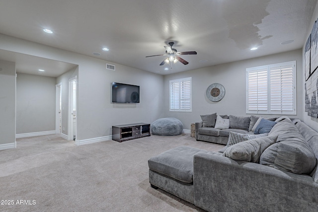 carpeted living room with ceiling fan