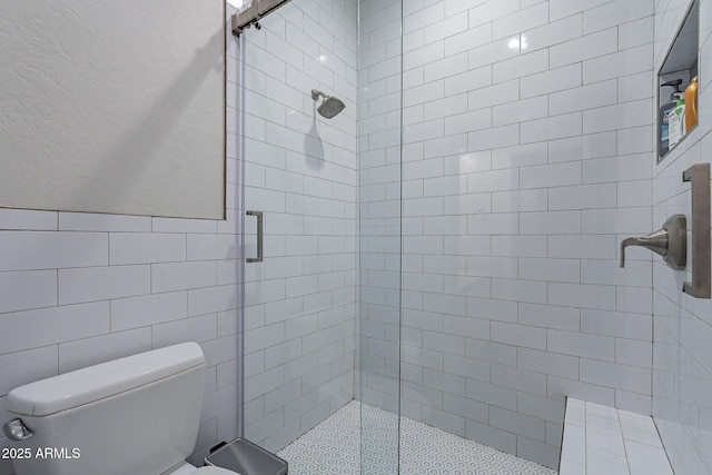 bathroom featuring toilet, walk in shower, and tile walls