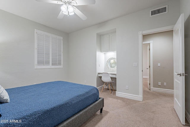 bedroom with ceiling fan and light carpet