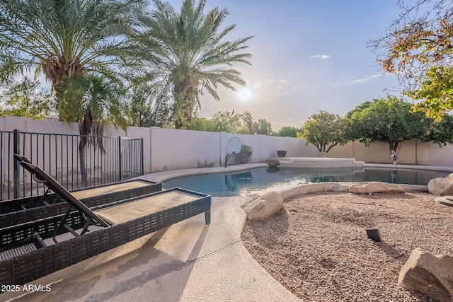 pool at dusk featuring a patio