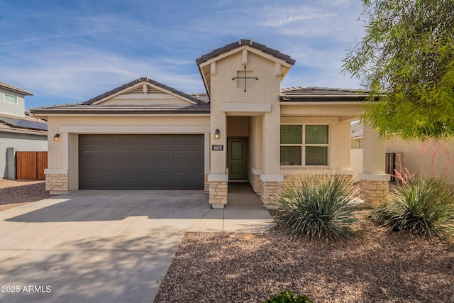 view of front of home with a garage, stucco siding, driveway, and stone siding