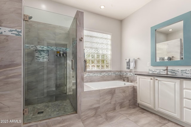 full bath with a bath, a stall shower, and vanity