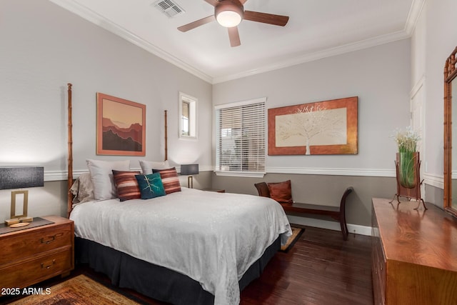 bedroom with dark wood-type flooring, baseboards, visible vents, and ornamental molding
