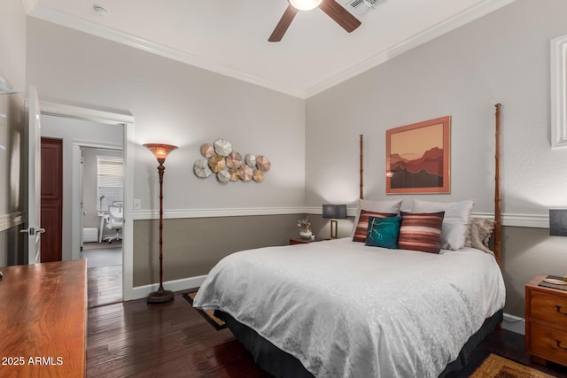 bedroom with visible vents, ornamental molding, dark wood finished floors, baseboards, and ceiling fan