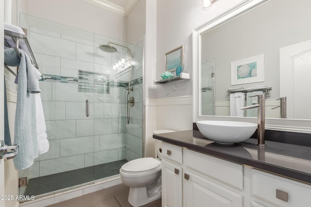 full bath with vanity, crown molding, a shower stall, and toilet