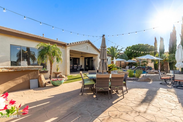 view of patio featuring outdoor dining space and ceiling fan