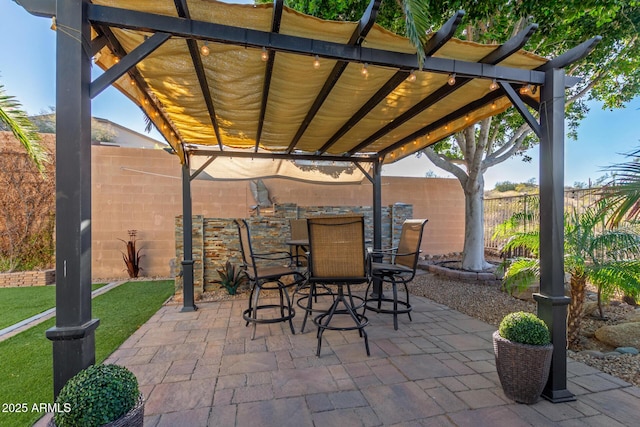 view of patio / terrace featuring outdoor dining area, a fenced backyard, and a pergola
