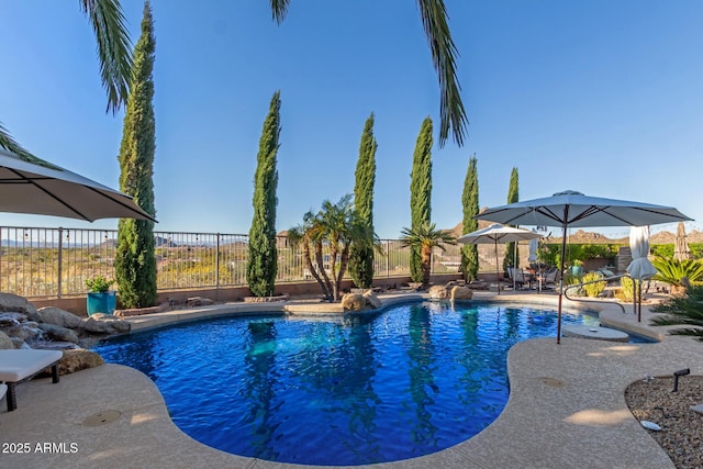view of swimming pool with a fenced in pool, a patio, and fence