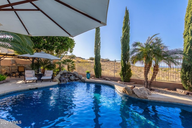 view of swimming pool with a fenced in pool, a patio, and fence