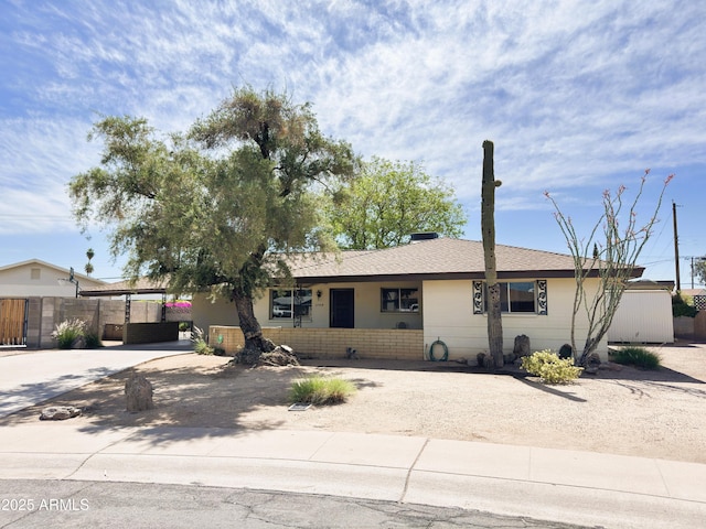 ranch-style house with fence and driveway