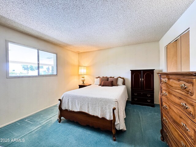 bedroom with baseboards, a textured ceiling, and dark carpet