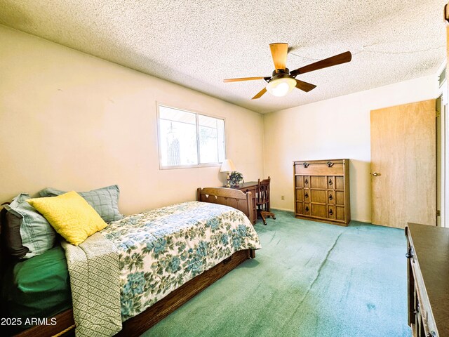 bedroom with carpet flooring, a textured ceiling, and ceiling fan
