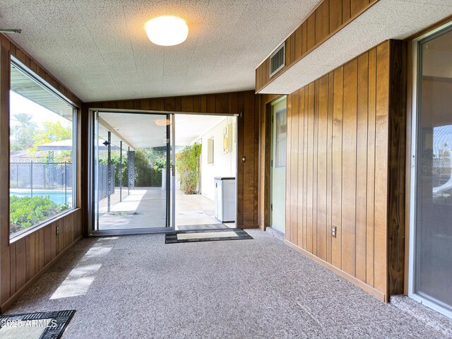 interior space featuring visible vents and wooden walls