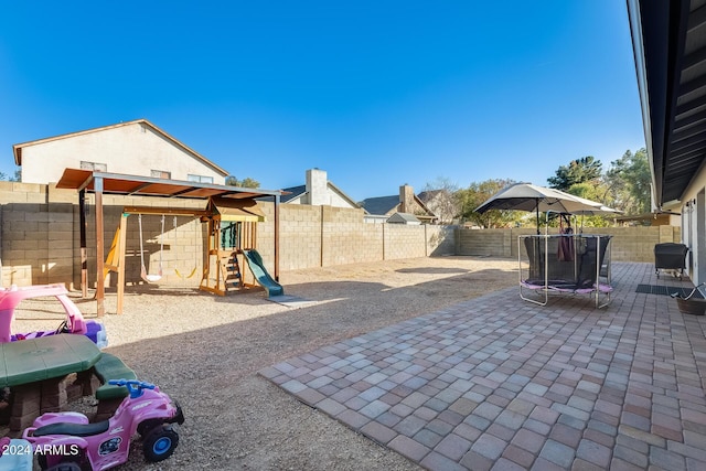 view of patio with a playground and a trampoline