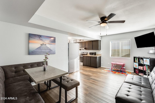 living room featuring light hardwood / wood-style flooring and ceiling fan