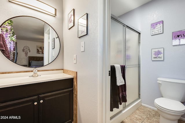 bathroom with toilet, vanity, tile patterned floors, and an enclosed shower