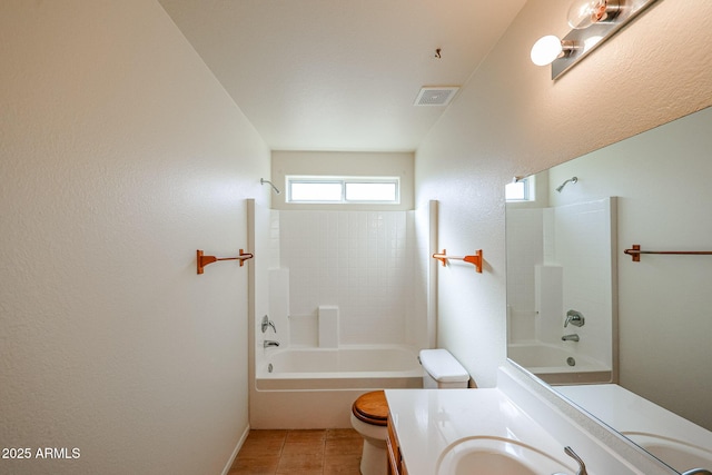 bathroom with bathing tub / shower combination, visible vents, toilet, vanity, and tile patterned flooring